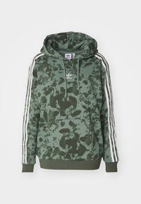 Green tie-dye hoodie with a front pocket, white three-stripe sleeves, and a drawstring hood. Features Adidas logo on the chest.