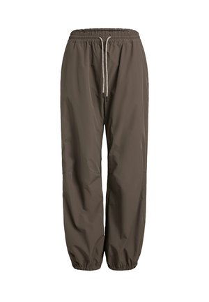 Hnědé, lehké a voděodolné kalhoty s elastickým pasem a stahovací šňůrkou. Úzký střih se staženými lemy u kotníků.