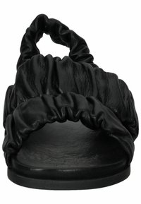 Sandale plate noire avec brides froncées sur les orteils et autour de la cheville, avec une semelle texturée et un design à bout ouvert.