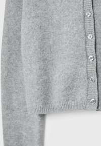 Cardigan en laine gris clair à manches longues avec sept boutons assortis le long de l'ouverture devant.