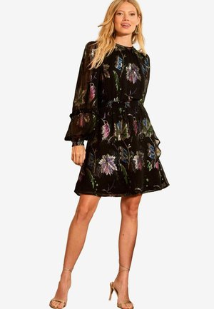 Black dress with floral embroidery in vibrant colors, sheer long sleeves, and a fitted waist. Features delicate balloon sleeves and a flared skirt.