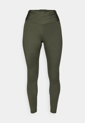 Leggings verde-oliva com uma cintura alta e cruzada. Tecido liso e elástico, com um silhueta justa e sem costuras visíveis.