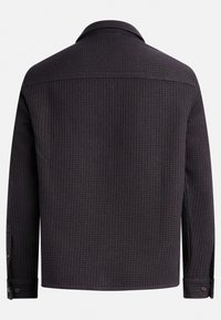 Black textured jacket with a grid pattern, featuring a collar and buttoned cuffs, designed with a relaxed fit and no visible hardware.