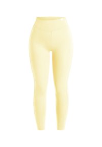 Leggings taille haute jaune pâle avec une coupe lisse et ajustée, sans motifs ni poches visibles, présentés sur fond blanc.
