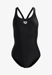 Black one-piece swimsuit with thin, crossed straps. Made from smooth, stretchy fabric. Features a white logo on the chest.