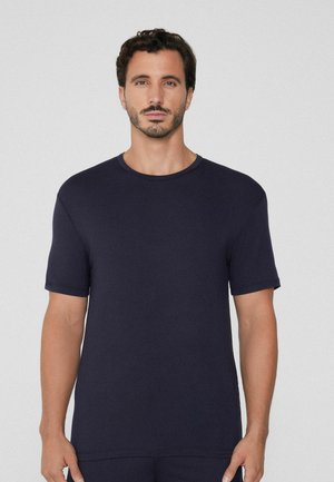 Camiseta de manga corta azul navy hecha de algodón. Cuenta con un escote redondo, textura suave y un ajuste relajado. Diseño minimalista.