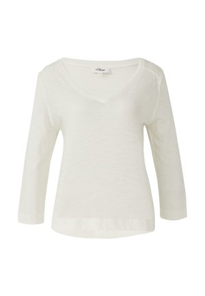 Kohandatud varrukatega, V-kaelusega ülemine osa heleses toonis, valmistatud kergest kangast. Omab vabalt langevat lõiget ja õmmeldud servi lisatud vastupidavuseks.