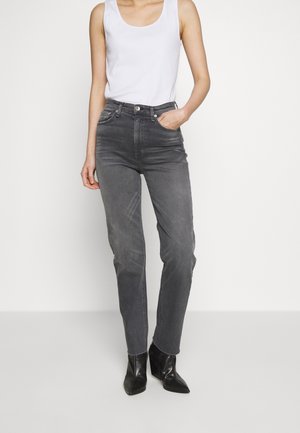 Gray denim jeans with a slim fit, high waist, and five-pocket design; paired with a basic white tank top and black heeled boots.
