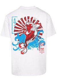White short-sleeve t-shirt featuring a red and blue koi fish graphic, stylized waves, and Japanese text accents in contrasting colors.
