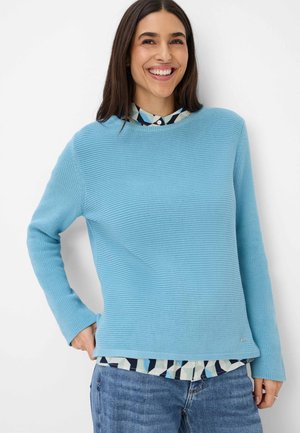 Blue textured knit sweater with long sleeves, round neckline, and layered over a patterned shirt. Classic design with a relaxed fit.
