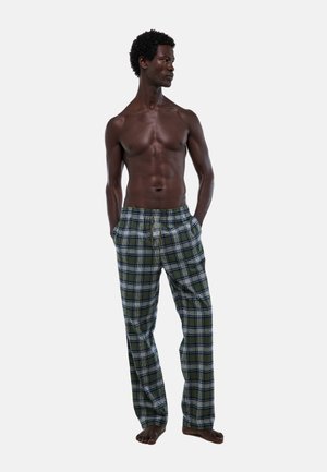 Pantalons de pyjama à carreaux en vert, bleu et blanc, fabriqués en tissu doux. Dotés d'une taille élastique et d'une coupe ample, avec des poches.