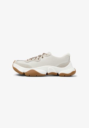 Light gray sneaker with textured leather and mesh inserts. Features brown laces and a thick white sole with gum accents. Rounded shape.