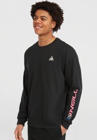 Black long-sleeve t-shirt made of cotton. Features a small multicolor triangle logo on the chest and pink "O'Neill" text down the arm.