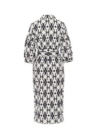Robe à motifs noir et blanc avec un col, des manches bouffantes et une ceinture assortie à la taille. Silhouette de longueur intermédiaire.