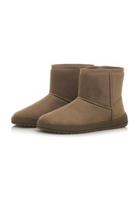 Stivaletti alla caviglia in suede marrone con una robusta suola in gomma, punta tonda e dettagli cuciti lungo i lati. Foderatura interna morbida visibile.