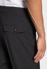 Weekday FRANKLIN FLARED TROUSERS - Calças - black