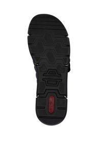 Black rubber shoe sole featuring a geometric, hexagonal tread pattern and embossed brand logo. Flat with textured grip for traction.