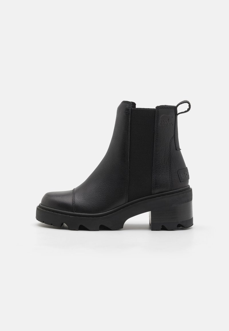 Black ankle boots with a smooth leather upper, elastic side panels, and a chunky rubber sole featuring a serrated tread for grip.