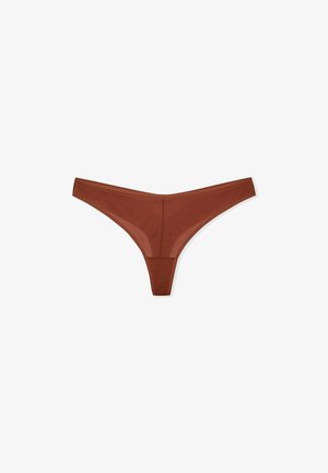 Tanga trasparente marrone con copertura minima. Caratterizzato da un tessuto morbido e leggero, cuciture piatte e una cintura stretta per una vestibilità senza cuciture.
