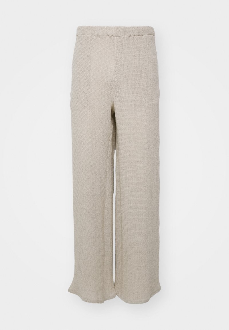 Beige wide-leg bukser lavet af struktureret stof, der har en høj talje og et enkelt, rent design uden synlige lukninger eller udsmykninger.