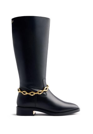 Black knee-high leather boot with low heel and decorative gold chain around the ankle.