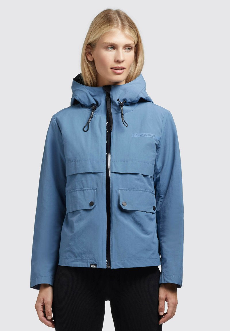 Blue lightweight jacket with a hood, featuring two front pockets, zip closure, and drawstring accents, crafted from smooth synthetic material.