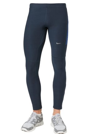 Leggings de sport bleu marine en tissu extensible, avec un panneau en maille géométrique sur le côté droit et un logo argenté à l'avant.