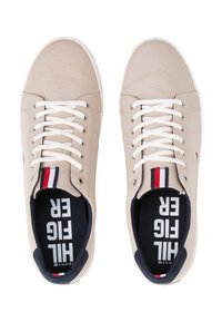 Sneakers in tela beige con lacci bianchi, suole in gomma e interno navy. Presentano un dettaglio a righe rosse e bianche sulla linguetta.