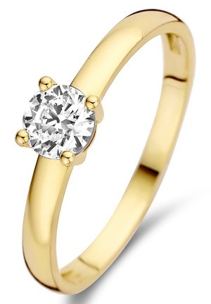 Bague en or avec un diamant rond taillé en brillant maintenu par quatre griffes. Anneau lisse et poli avec un profil arrondi. Design simple et élégant.