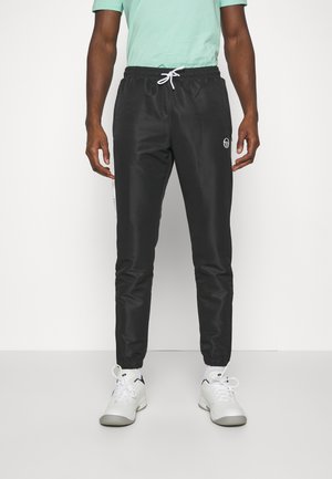 Schwarze Sporthose mit elastischem Bund und weißem Kordelzug, ausgestattet mit einem seitlichen Logo und einer schmal zulaufenden Passform am Knöchel.