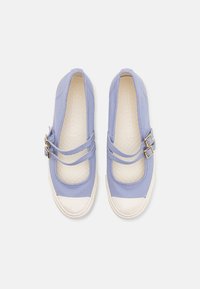 Jasnofioletowe płócienne buty na płaskiej podeszwie z dwoma paskami na klamry, białym gumowym noskiem i teksturowaną wkładką wewnętrzną z wzorem diamentowym.