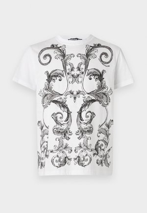 White cotton t-shirt featuring intricate black baroque-style floral patterns on the front. Round neckline and short sleeves.