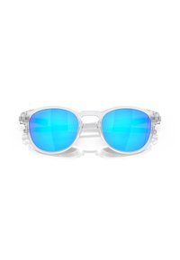 Occhiali da sole con montatura trasparente e lenti blu reflective. Forma arrotondata con hardware minimale e un design elegante. Texture liscia.