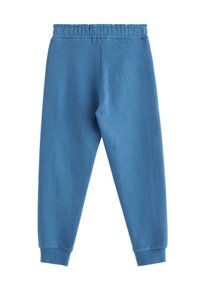 Niebieskie bawełniane spodnie dresowe z elastycznym pasem, zwężanymi mankietami i gładką fakturą. Brak kieszeni oraz elementów dekoracyjnych.