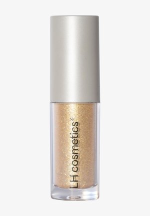 Flacon cylindrique transparent avec un bouchon argenté contenant un liquide cosmétique doré pailleté étiqueté LH cosmetics.