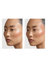 Two side-by-side profiles of a face with smooth skin, subtle highlighter on cheeks, and natural makeup; hair tied back, neutral background.
