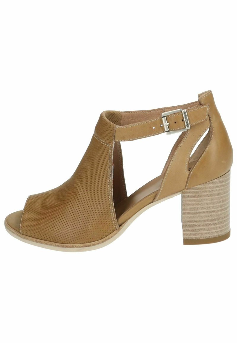 Tan open-toe shoe with perforated front, ankle strap, and silver buckle. Features a stacked, textured heel. Smooth inner lining.