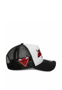 Black and white trucker cap with a rigid front, mesh back, featuring a red bull logo and "BULLS" text, with a curved visor and adjustable strap.