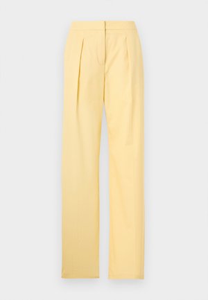 Pantalon jaune taille haute, jambes droites, avec plis avant et fermeture éclair invisible, présenté sur un fond blanc uni.