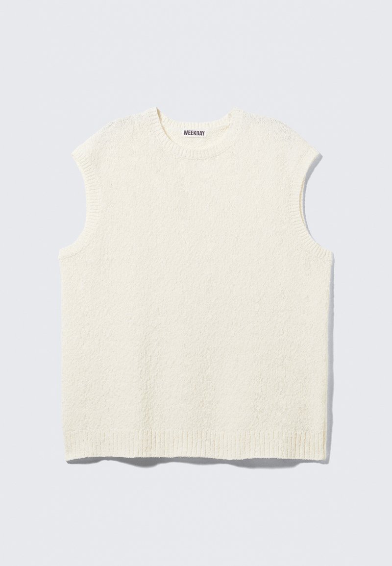Cream-colored sleeveless top with a textured design, ribbed neckline, and hem. Features a boxy fit and casual style.