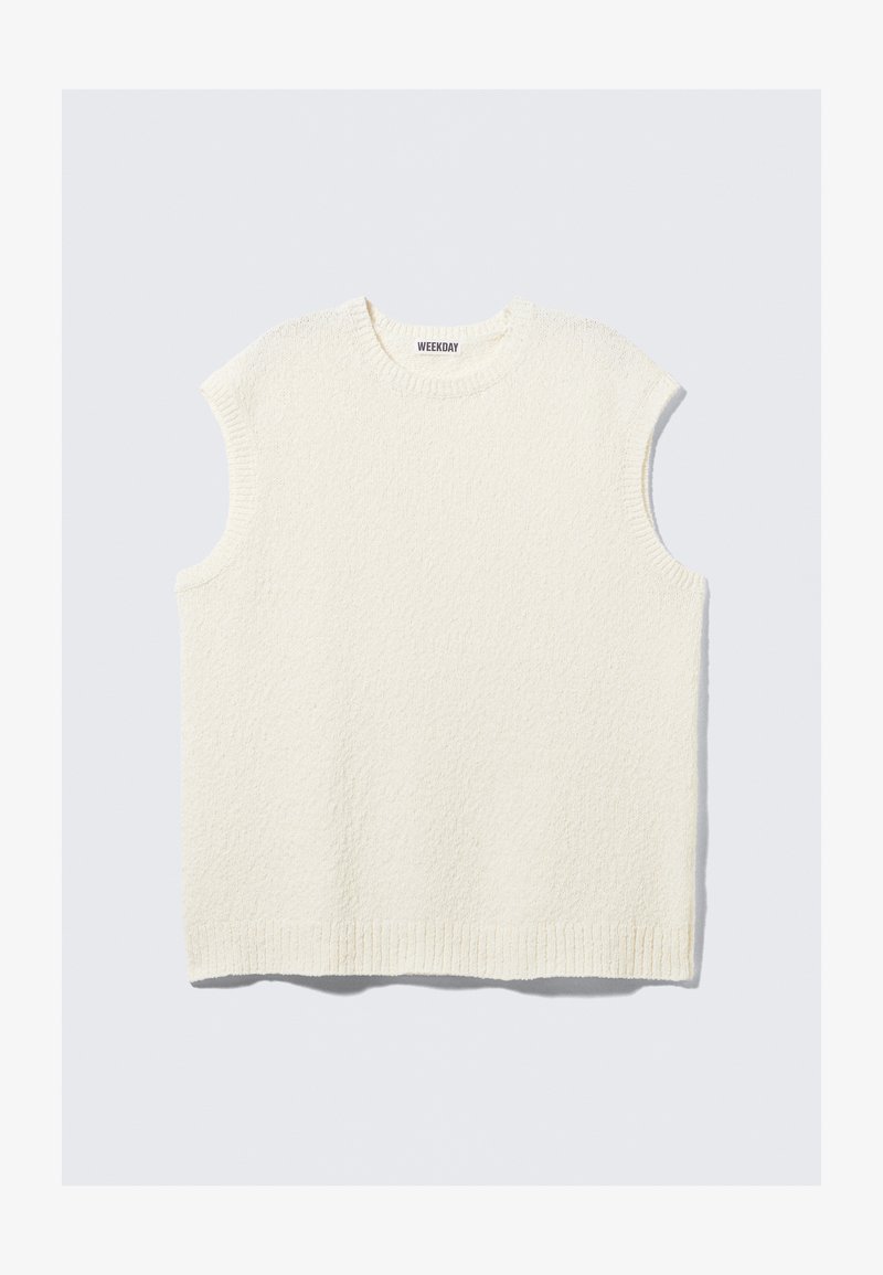 Cream-colored sleeveless top with a textured design, ribbed neckline, and hem. Features a boxy fit and casual style.