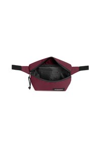 Červená látková taštička s uzavíráním na zip, černou podšívkou a malou vnitřní kapsou. Obsahuje rukojeť a značkovou etiketu na přední straně.