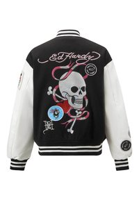 Black and white varsity jacket featuring embroidered skull, heart, and crossbones designs, with ribbed cuffs and collar, and patches on sleeves.