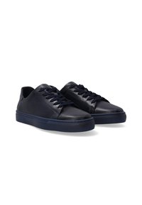 Navy blue leather sneakers with a smooth texture, rounded toe, central lacing, and rubber sole for grip. Minimalist design with a casual look.