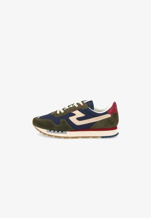 Sneakers with a mix of olive green suede and navy fabric, white laces, and a red accent on the heel. Features a textured sole.