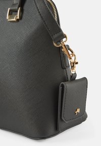 Černá texturovaná kabelka se zlatým zipem a kovovými doplňky, s odnímatelnou malou taštičkou ve stejném stylu připevněnou na boku.