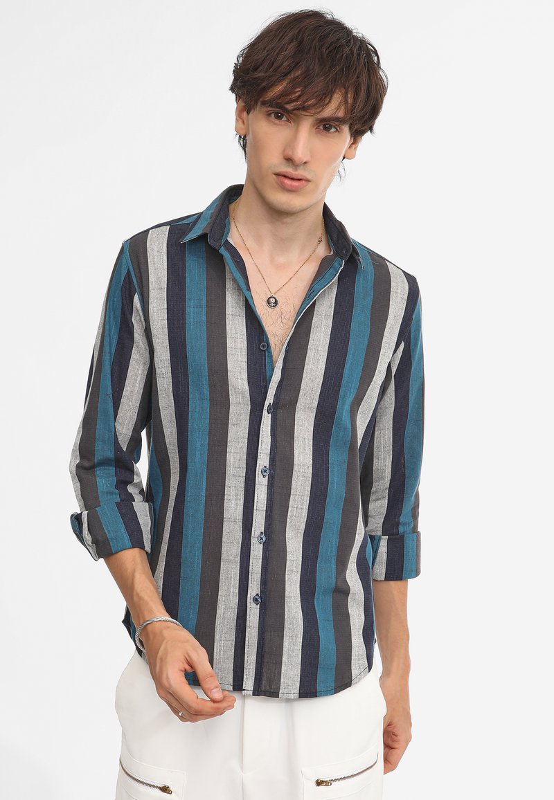 Striped button-up shirt featuring dark blue, teal, and gray vertical stripes. Long sleeves, single chest pocket, and a relaxed fit.