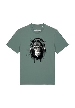 T-shirt vert à manches courtes avec un graphique d’un singe portant de grands écouteurs avec des effets d’éclaboussures de peinture noire.