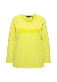 T-shirt giallo a maniche lunghe con collo rotondo e bordo ribbed. Presenta la parola "Bellezza" in un finish lucido sulla parte anteriore. Tessuto morbido.