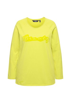 T-shirt à manches longues jaune avec un col rond et des finitions côtelées. Présente le mot "Beauté" en finition brillante sur le devant. Tissu doux.